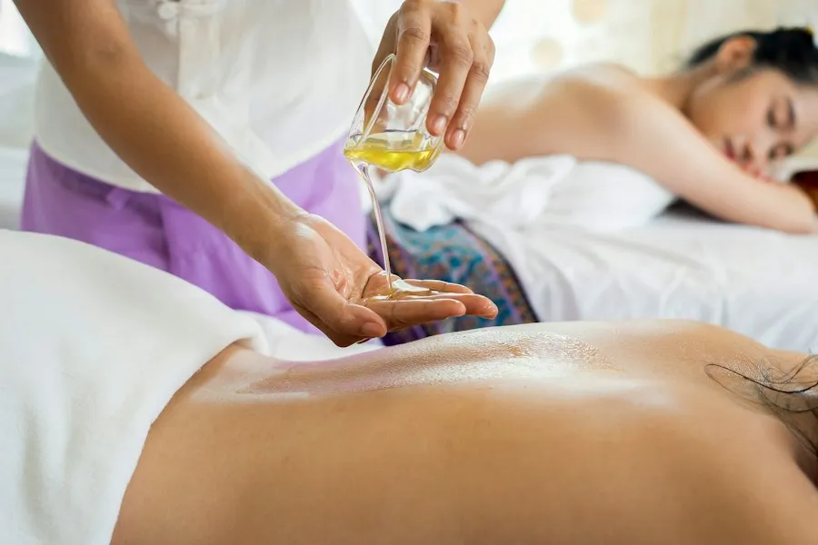 Oil being poured during a massage treatment